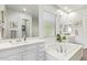 Main bathroom with double vanity and a large soaking tub at 22917 E Camina Buena Vis, Queen Creek, AZ 85142