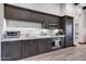 Well-equipped kitchenette with dark wood cabinets and granite countertops at 24258 N 91St St, Scottsdale, AZ 85255