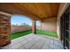 Covered patio with artificial turf and brick columns at 24258 N 91St St, Scottsdale, AZ 85255