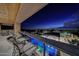 Night view of a luxurious pool and patio area with city views at 24258 N 91St St, Scottsdale, AZ 85255