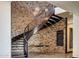 Modern curved staircase with brick wall and unique light fixture at 24258 N 91St St, Scottsdale, AZ 85255