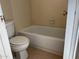 Bathroom with bathtub, toilet, and tiled floor at 2429 E Calypso Ave, Mesa, AZ 85204