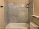 Bathroom with marble tile shower/tub combo and vanity at 2429 E Calypso Ave, Mesa, AZ 85204