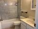 Updated bathroom with marble tile and white vanity at 2429 E Calypso Ave, Mesa, AZ 85204