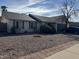 House with gravel landscaping and a blue car parked in the driveway at 2429 E Calypso Ave, Mesa, AZ 85204