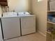 Laundry room with washer, dryer, and shelving at 2429 E Calypso Ave, Mesa, AZ 85204