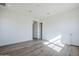 Bright bedroom with hard wood floors, neutral walls, and access to an ensuite bathroom at 24642 N 123Rd Pl, Scottsdale, AZ 85255