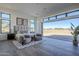 Bright bedroom boasts an oversized window, modern decor, and desert views at 24642 N 123Rd Pl, Scottsdale, AZ 85255