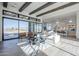 Bright living room with wood floors, beamed ceilings, large sliding glass doors and modern furnishings at 24642 N 123Rd Pl, Scottsdale, AZ 85255