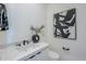 Powder room featuring modern black fixtures, a vessel sink, and an elegant art piece at 24642 N 123Rd Pl, Scottsdale, AZ 85255