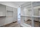 Well-organized walk-in closet with white shelving and drawers at 24642 N 123Rd Pl, Scottsdale, AZ 85255