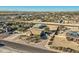 Aerial view of property showcasing house, detached shop, and surrounding landscape at 2602 S 226Th Dr, Buckeye, AZ 85326