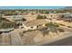 Aerial view of single-story home with detached shop, large yard, and paved driveway at 2602 S 226Th Dr, Buckeye, AZ 85326