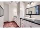 Bathroom with white cabinets, vessel sink, and hardwood floors at 2602 S 226Th Dr, Buckeye, AZ 85326