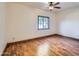 Simple bedroom with hardwood floors and a window at 2602 S 226Th Dr, Buckeye, AZ 85326