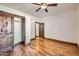 Hardwood floor bedroom with ceiling fan and built-in closet at 2602 S 226Th Dr, Buckeye, AZ 85326