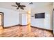 Hardwood floors and a ceiling fan accent this bright bedroom at 2602 S 226Th Dr, Buckeye, AZ 85326