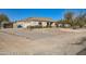 Single-story home with a large front yard, driveway, and walkway at 2602 S 226Th Dr, Buckeye, AZ 85326