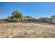 Rear view of a house with a covered patio and a large yard at 2602 S 226Th Dr, Buckeye, AZ 85326