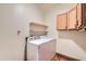 Laundry room with washer, dryer, and overhead shelving at 2602 S 226Th Dr, Buckeye, AZ 85326