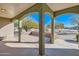 Covered patio with brick flooring and arched columns at 2602 S 226Th Dr, Buckeye, AZ 85326