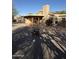 Landscaped backyard with gravel and covered patio at 26034 S Glenburn Dr, Sun Lakes, AZ 85248