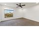 Bright bedroom featuring ceiling fan and large window at 26034 S Glenburn Dr, Sun Lakes, AZ 85248