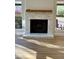 Modern fireplace with light stone and wood mantel at 26034 S Glenburn Dr, Sun Lakes, AZ 85248