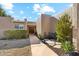 Welcoming walkway leads to a charming entryway with a wooden door at 26034 S Glenburn Dr, Sun Lakes, AZ 85248