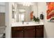 Clean bathroom with a single vanity, large mirror, and stylish decor at 26783 W Piute Ave, Buckeye, AZ 85396