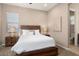 Bright bedroom with a queen-size bed, nightstands, and en-suite bathroom at 26783 W Piute Ave, Buckeye, AZ 85396