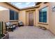 Inviting front courtyard with seating area and brick pavers at 26783 W Piute Ave, Buckeye, AZ 85396