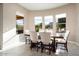 Bright dining area with large windows and seating for six at 26783 W Piute Ave, Buckeye, AZ 85396