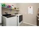 Laundry room with washer, dryer, and extra shelving for storage at 26783 W Piute Ave, Buckeye, AZ 85396