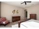 Main bedroom with dresser, chair, and large bed at 26783 W Piute Ave, Buckeye, AZ 85396