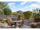 Peaceful patio with a table and chairs, surrounded by desert landscaping at 26783 W Piute Ave, Buckeye, AZ 85396