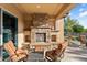 Relaxing patio with a fireplace and comfortable seating at 26783 W Piute Ave, Buckeye, AZ 85396