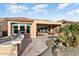 Large patio with seating area, outdoor kitchen, and mountain views at 26783 W Piute Ave, Buckeye, AZ 85396