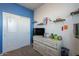 Bedroom with a dresser, TV, and shelving at 31063 W Cheery Lynn Rd, Buckeye, AZ 85396