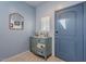 Entryway with light blue walls, antique dresser, and mirror at 31063 W Cheery Lynn Rd, Buckeye, AZ 85396