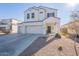 Two-story house with white exterior, two-car garage, and landscaped yard at 31063 W Cheery Lynn Rd, Buckeye, AZ 85396