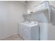 Laundry room with washer, dryer, and overhead shelving at 31063 W Cheery Lynn Rd, Buckeye, AZ 85396