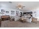 Bright living room with a piano, sectional sofa, and access to the kitchen at 31063 W Cheery Lynn Rd, Buckeye, AZ 85396