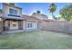 Spacious backyard with covered patio, grassy lawn, and block wall for privacy at 3134 E Mckellips Rd # 168, Mesa, AZ 85213