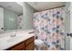 Bathroom with floral shower curtain, wood vanity, and updated fixtures at 3134 E Mckellips Rd # 168, Mesa, AZ 85213