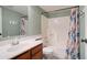 Bathroom with floral shower curtain, wood vanity, and updated fixtures at 3134 E Mckellips Rd # 168, Mesa, AZ 85213