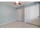 Bedroom with ceiling fan, light blue walls, and double door closet at 3134 E Mckellips Rd # 168, Mesa, AZ 85213