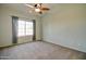 Spacious bedroom with ceiling fan and large window at 3134 E Mckellips Rd # 168, Mesa, AZ 85213