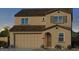 Two-story home with tan exterior, brown roof, and two-car garage at 3609 E Peralta Canyon Ln, San Tan Valley, AZ 85140