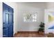 Inviting entryway with blue door, terracotta tile floor, and plant at 3715 N 9Th Pl, Phoenix, AZ 85014